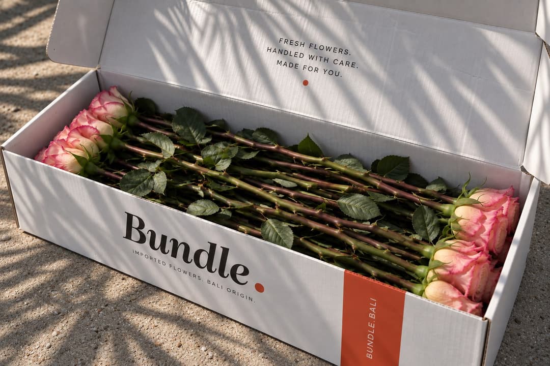 A Bundle. box beside an armful of flowers in a vase